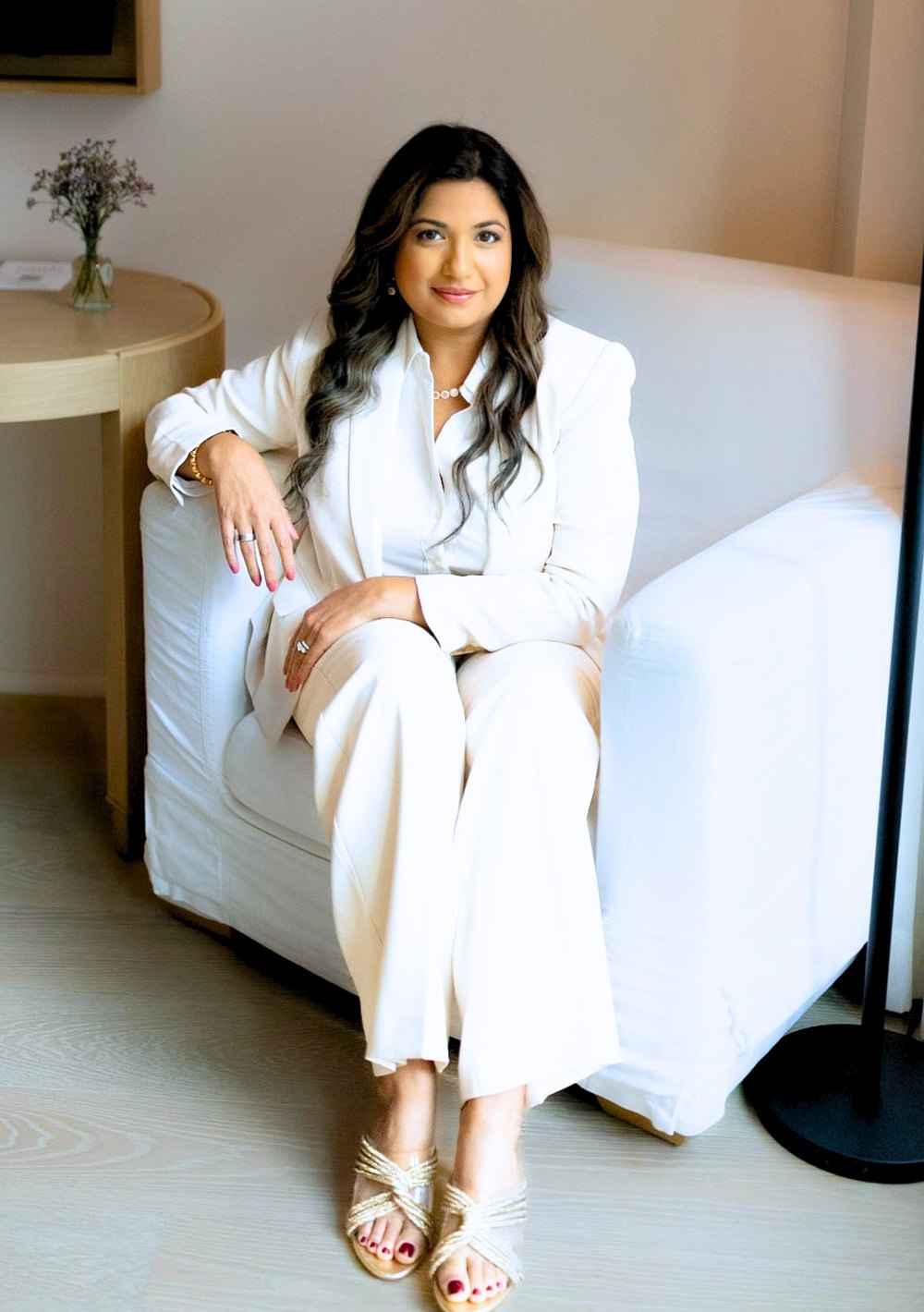Anita Albert-Watson seated in a white suit